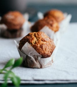 Healthy pumpkin muffins freshly baked on counter in parchment paper