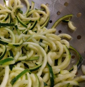 Spiralized zucchini in a bowl, also called zoodles; these are a healthy alternative to noodles in this chicken zoodle soup recipe